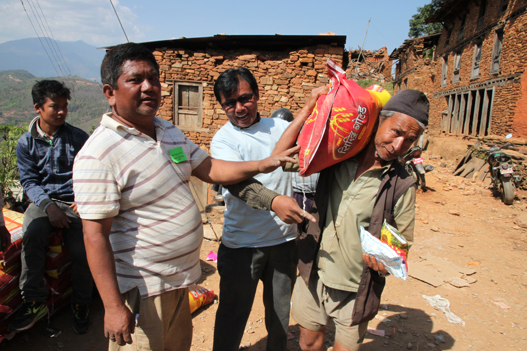 Giving man bag of rice Nepal